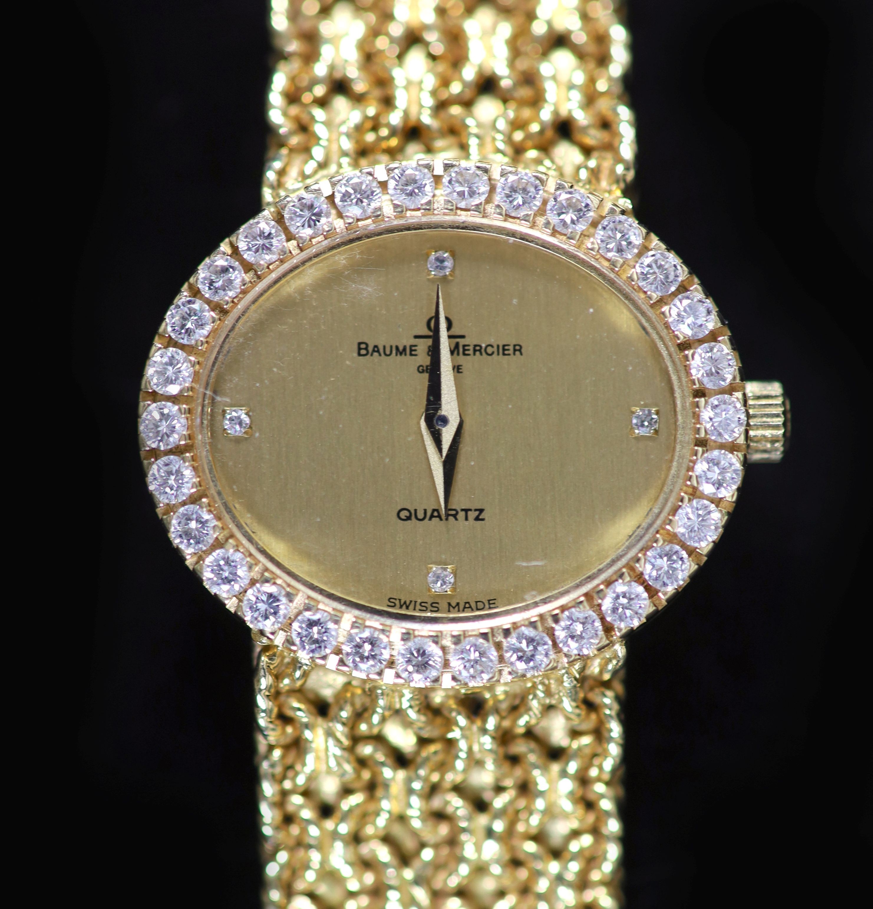 A lady's 18ct gold Baume & Mercier quartz oval dress bracelet wrist watch, with diamond set bezel